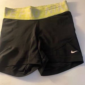 Women's nike pros- black with yellow band size adult xs